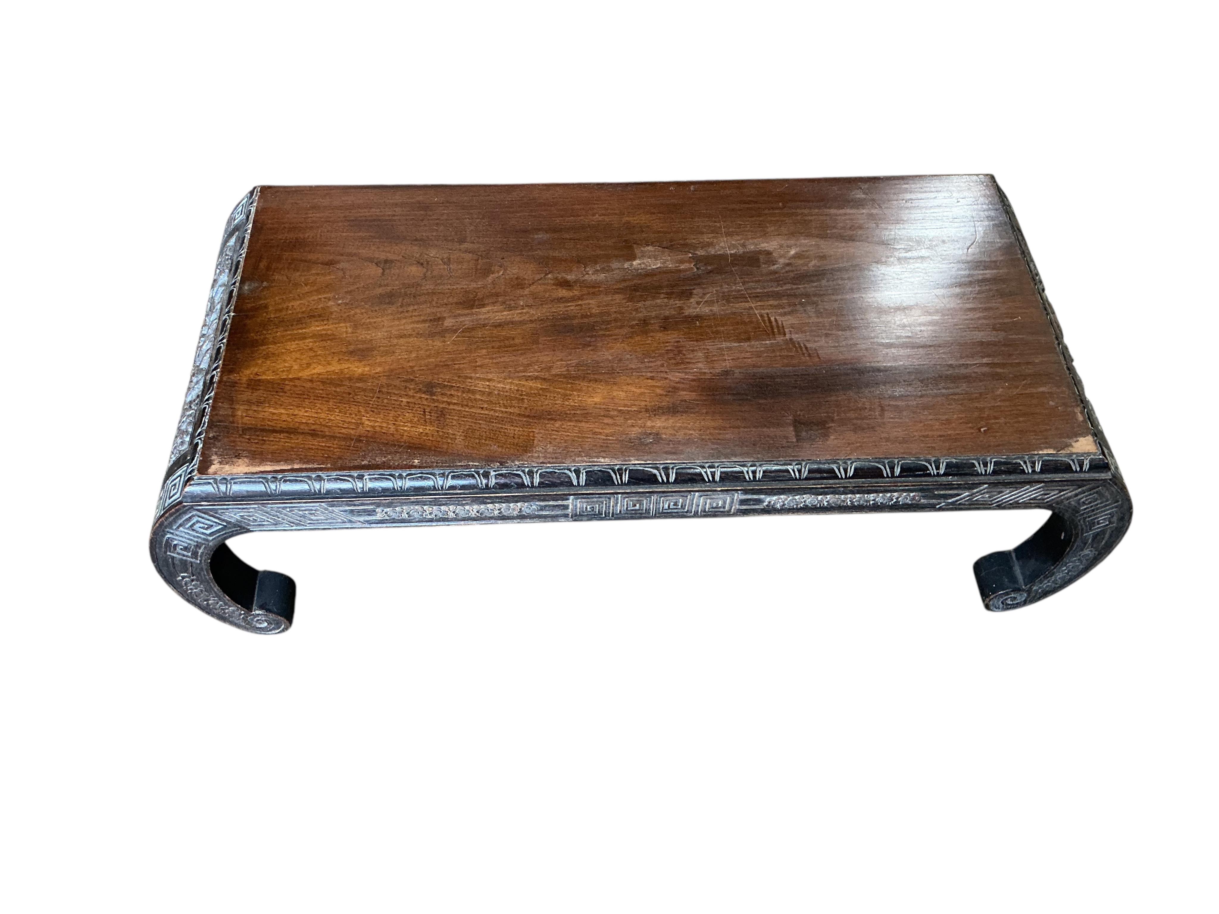 A Chinese carved low table, width 92cm, depth 40cm, height 28cm